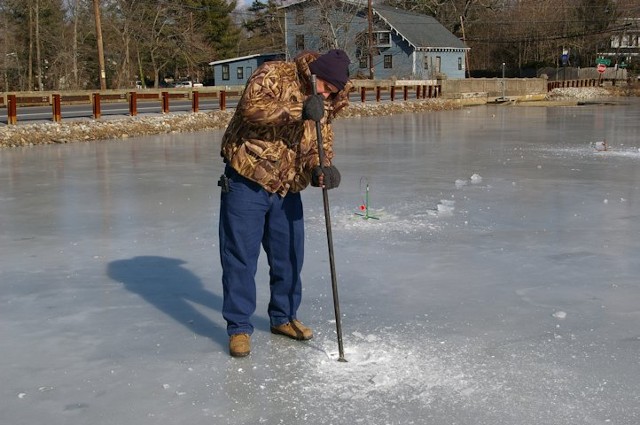 ice fisherman with spud bar